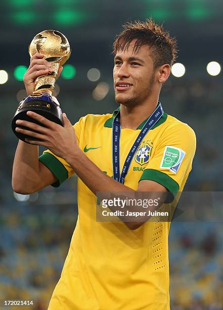 Neymar of Brazil holds the FIFA Confederations Cup trophy after the FIFA Confederations Cup Brazil 2013 Final match between Brazil and Spain at...