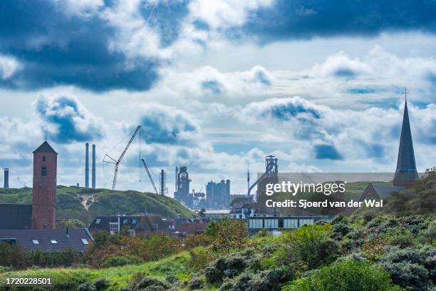 Wijk aan Zee village in the dunes with the Tata Steel steel mill in the background on October 5 ,2023 in Wijk aan Zee. Tata steel is one of the major...