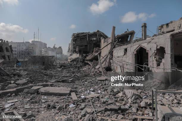 Palestinians inspect the damage following an Israeli airstrike on the El-Remal aera in Gaza City on October 12, 2023.