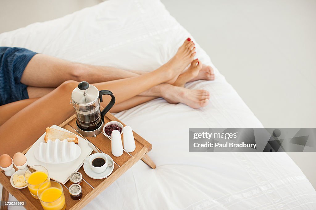 Couple having breakfast in bed