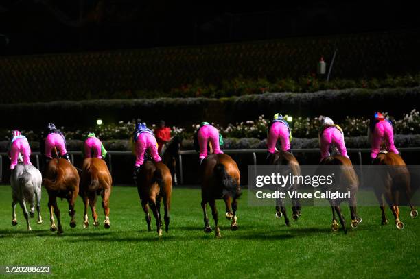 Jockeys wearing Pink silks to support Breast Cancer Network Australia in Race 5, the Breast Cancer Network Australia Handicap, during Melbourne...