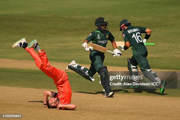 Saud Shakeel and Mohammad Rizwan of Pakistan run between the wickets as Paul van Meekeren of Netherlands falls to ground after a delivery during the...