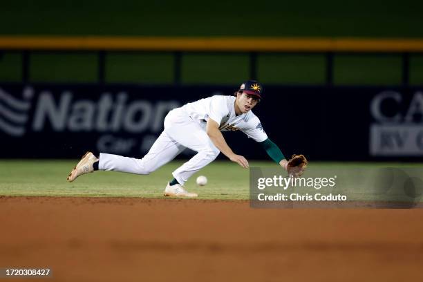 Max Muncy of the Mesa Solar Sox attempts to field a ground ball during the game between the Glendale Desert Dogs and the Mesa Solar Sox at Sloan Park...