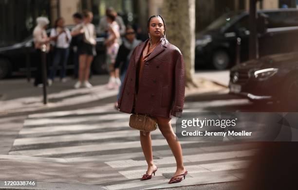 Paola Locatelli is seen wearing a cognac leather jacket, a red-brown oversized leather jacket, an orange dress and a brown Arcadie Miu Miu handbag...