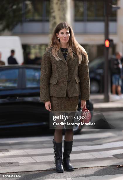 Veronika Heilbrunner is seen wearing a black top, an olive green knit blazer and an olive green knit skirt, black tights, high black leather boots,...