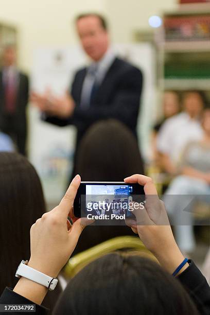 British Prime Minister David Cameron is viewed through a smartphone camera as he addresses students during a PM Direct event at Nazarbayev University...