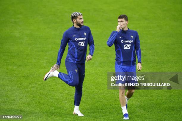 Fance's defender Theo Hernandez speaks with France's defender Benjamin Pavard during a training session at the Johan Cruijff stadium, in Amsterdam on...