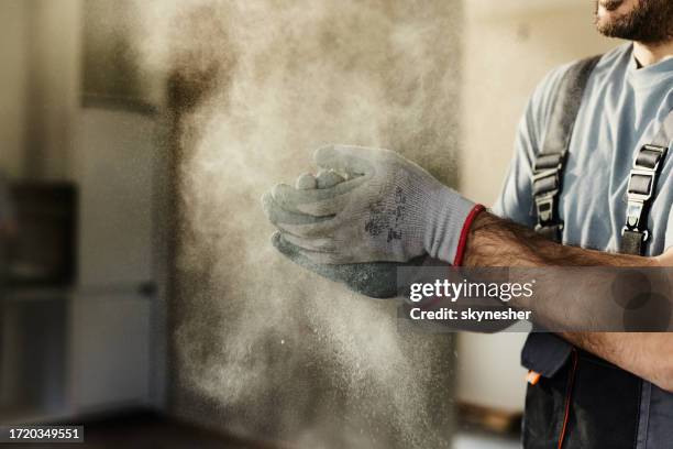 cleaning dust from protective gloves! - sawdust stock pictures, royalty-free photos & images