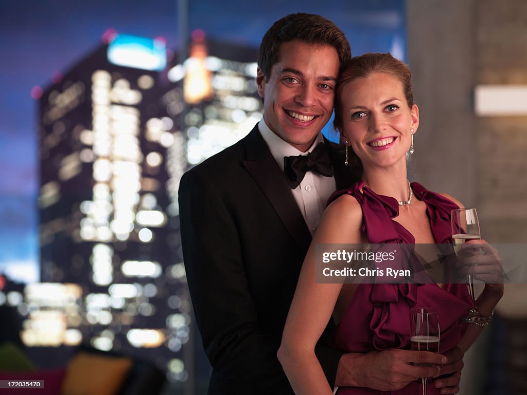 Elegant couple drinking Champagne at night