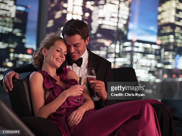 elegant couple drinking champagne at night - women of penthouse 個照片及圖片檔