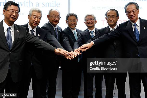 Akio Toyoda, president of Toyota Motor Corp., center, poses for a photograph with company's executive vice presidents, from left, Yasumori Ihara,...