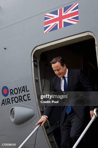 British Prime Minister David Cameron steps down from a C17 Globemaster RAF transport plane after landing at Atyrau airport on July 1, 2013 in Atyrau,...