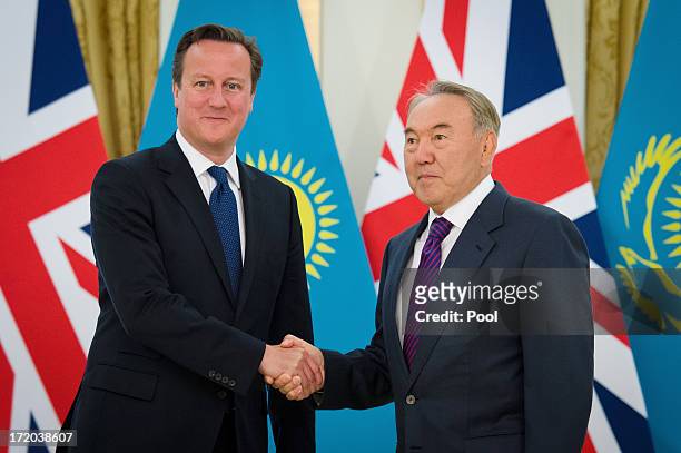 British Prime Minister David Cameron shakes hands with Kazakhstan President Nursultan Nazarbayev after arriving at the Presidential Palace on July 1,...