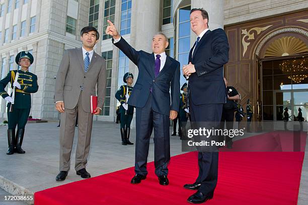 British Prime Minister David Cameron is greeted by Kazakhstan President Nursultan Nazarbayev as he arrives at the Presidential Palace on July 1, 2013...