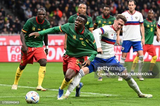 Russia's midfielder Anton Miranchuk fouls Cameroon's defender Nouhou Tolo during the international friendly football match between Russia and...