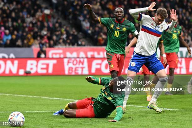 Russia's midfielder Anton Miranchuk fouls Cameroon's defender Nouhou Tolo during the international friendly football match between Russia and...