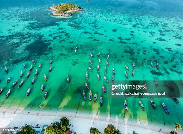 aerial view of longtail boats moored on the beach in koh lipe in thailand, asia - ko lipe stock pictures, royalty-free photos & images