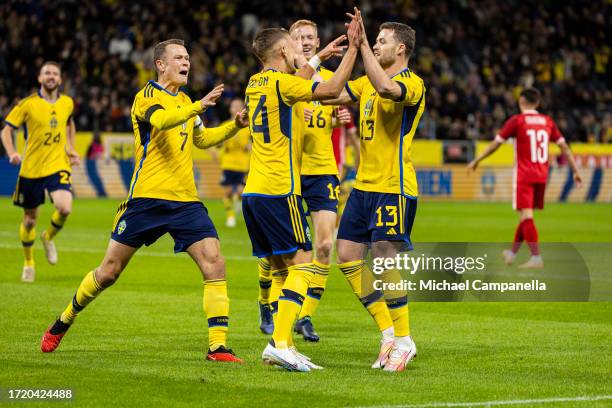 Sweden's Jesper Karlsson celebrates with teammates after scoring the 1-0 opening goal during the international friendly match between Sweden and...