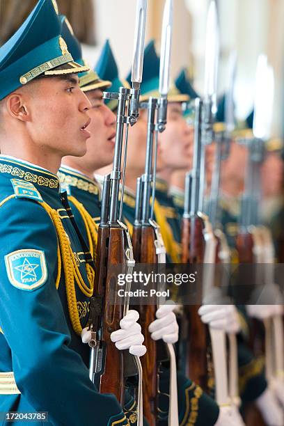 Soldiers sing the Kazakh national anthem during a welcome ceremony on the arrival of British Prime Minister David Cameron to meet with Kazakhstan...