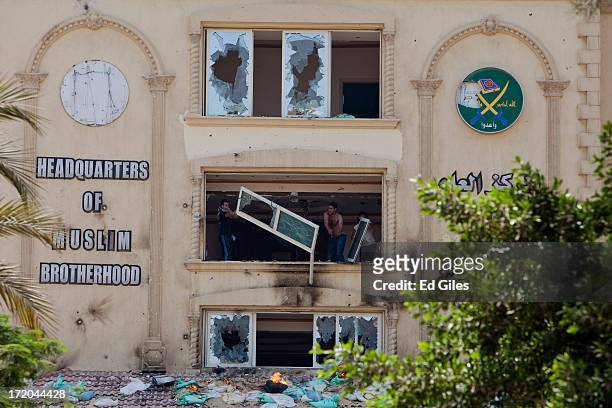 Protesters throw furniture from the windows of the headquarters of Egypt's Muslim Brotherhood as they ransack the building in the suburb of Muqattam...