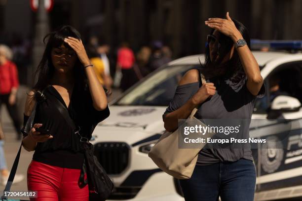 People use their hands to shield themselves from the sun on October 6 in Madrid, Spain. Unprecedented high temperature anomalies recorded globally...