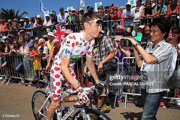 Polka dot jersey of best climber France's Pierre Rolland rides in Ajaccio before the start of the 145.5 km third stage of the 100th edition of the...