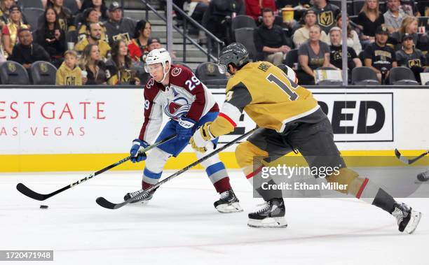 Nathan MacKinnon of the Colorado Avalanche skates with the puck against Nicolas Hague of the Vegas Golden Knights in the first period of their...