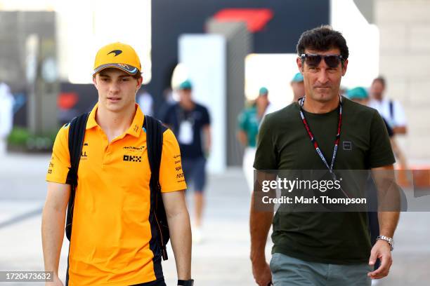 Oscar Piastri of Australia and McLaren and Mark Webber walk in the Paddock prior to practice ahead of the F1 Grand Prix of Qatar at Lusail...