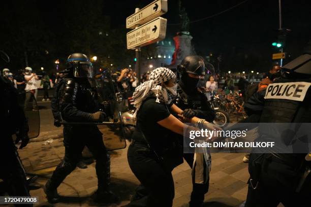 Protestor is detained by French Police during an unauthorized demonstration in support of Palestinians at Place de la Republique, in Paris, on...