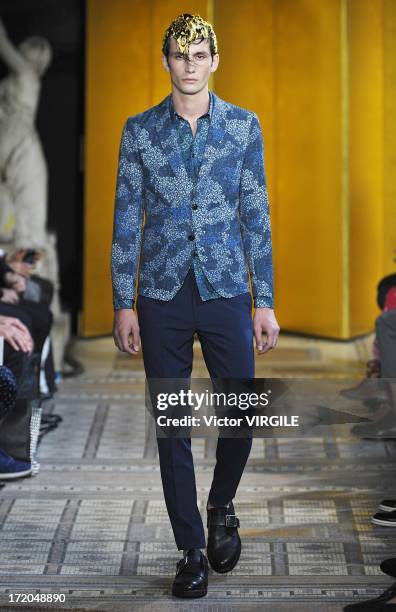 Model walks the runway during the Mihara Yasuhiro Ready to Wear Spring/Summer 2013 show as part of the Paris Men Fashion Week on June 29, 2012 in...