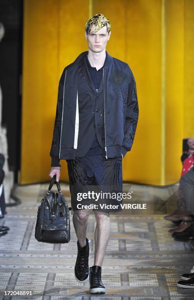 Model walks the runway during the Mihara Yasuhiro Ready to Wear Spring/Summer 2013 show as part of the Paris Men Fashion Week on June 29, 2012 in...