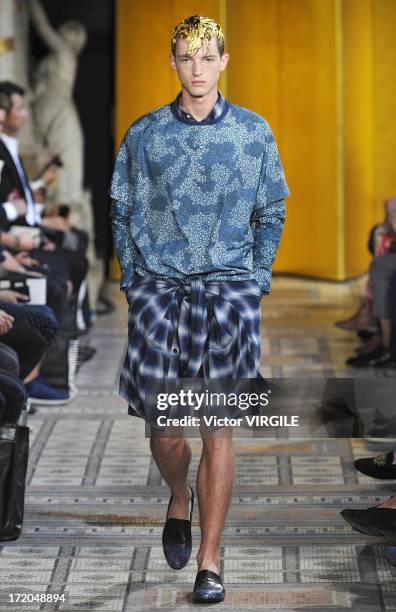 Model walks the runway during the Mihara Yasuhiro Ready to Wear Spring/Summer 2013 show as part of the Paris Men Fashion Week on June 29, 2012 in...