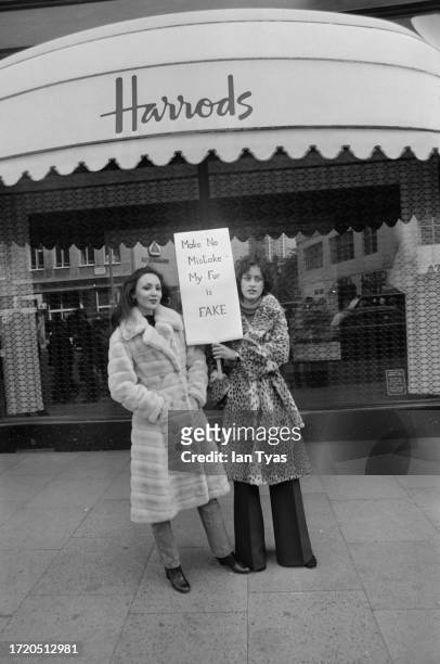 Models Marie Helvin and Nesta Beamish wearing fake fur coats during a protest outside Harrods in London, September 17th 1976. They are protesting...