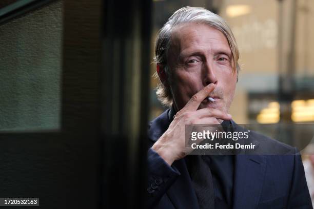 Mads Mikkelsen smokes ahead the "ZFF Masters: Mads Mikkelsen" during the 19th Zurich Film Festival at Arena 4 on October 06, 2023 in Zurich,...