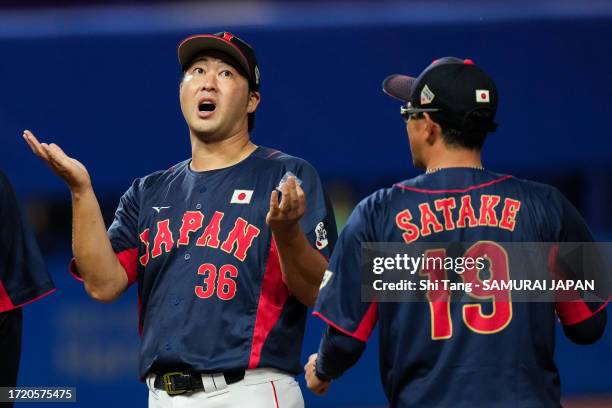 Junichi Tazawa of Team Japan reacts due to rain during the baseball Super Round game Japan and Chinese Taipei on day thirteen of the 19th Asian Games...