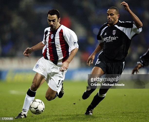 Youri Djorkaeff of Bolton holds off Alain Goma of Fulham during the FA Barclaycard Premiership match between Bolton Wanderers and Fulham at The...