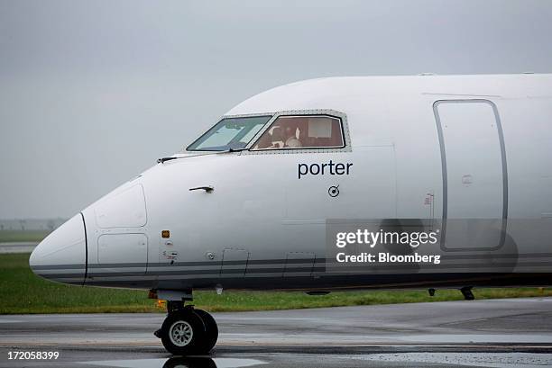 Porter Airlines Inc. Aircraft taxis on the runway at Billy Bishop Toronto City Airport in Toronto, Ontario, Canada, on Friday, June 28, 2013. Porter...