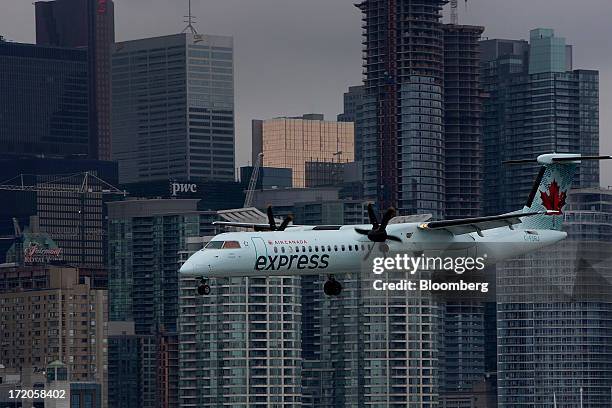 An Air Canada Express flight prepares to land at Billy Bishop Toronto City Airport in Toronto, Ontario, Canada, on Friday, June 28, 2013. Porter...