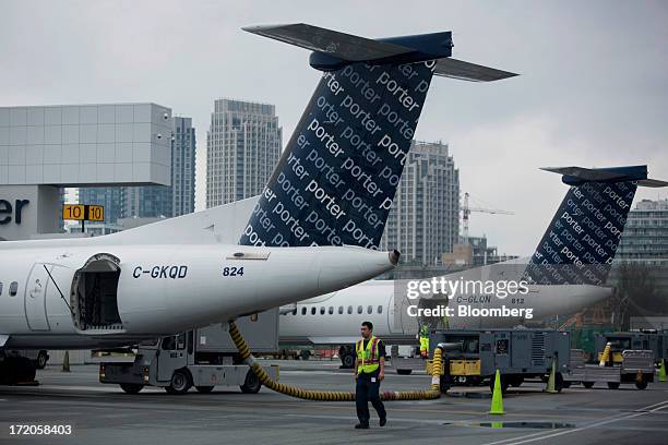 Porter Airlines Inc. Aircraft sit parked at Billy Bishop Toronto City Airport in Toronto, Ontario, Canada, on Friday, June 28, 2013. Porter Airlines...