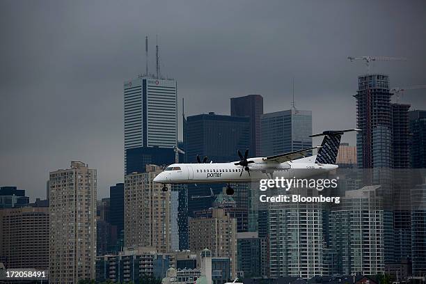 Porter Airlines Inc. Flight prepares to land at Billy Bishop Toronto City Airport in Toronto, Ontario, Canada, on Friday, June 28, 2013. Porter...