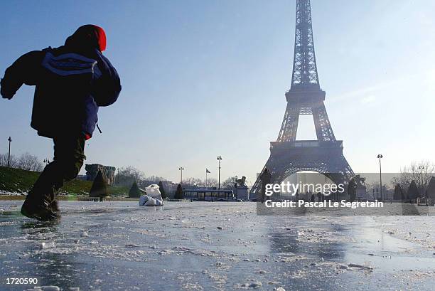 An unidentified child skates on the frozen Trocadero's fountain which is located near the Eiffel Tower January 11, 2003 in Paris, France. The...