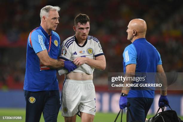 Scotland's defender Andrew Robertson leaves injured during the EURO 2024 first round group A qualifying football match between Spain and Scotland at...