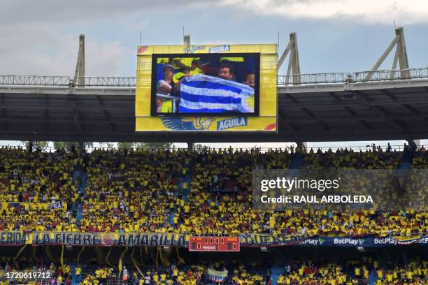 Fan of Uruguay is seen on the stadium's big screen as supporters of Colombia crowd the stands before the 2026 FIFA World Cup South American...