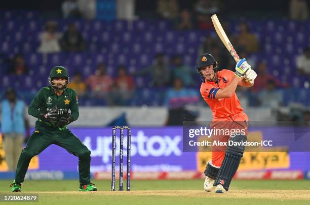 Bas de Leede of Netherlands plays a shot as Mohammad Rizwan of Pakistan looks on during the ICC Men's Cricket World Cup India 2023 between Pakistan...