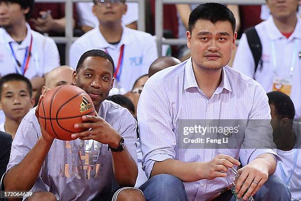 Yao Ming and NBA star Tracy McGrady watch the Yao Foundation Charity Game, sponsored by the charity foundation initiated by former Chinese basketball...