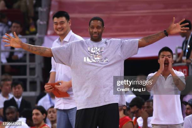 Star Tracy McGrady and Yao Ming watch the Yao Foundation Charity Game, sponsored by the charity foundation initiated by former Chinese basketball...