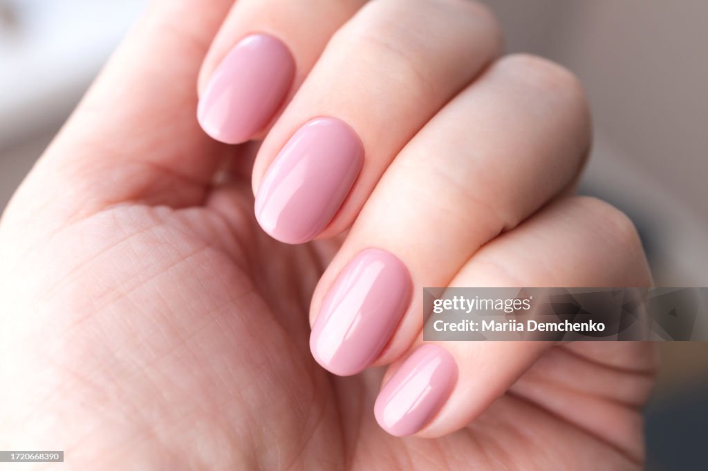 Hand with beautiful manicure - pink gel nails