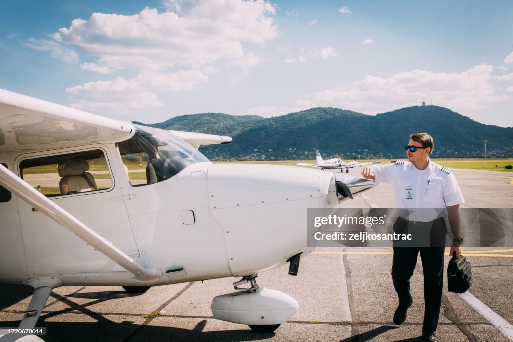 The pilot checks the plane before take off
