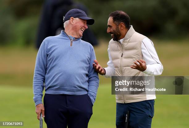 Martin Slumbers, Chief Executive of the R&A and Non-Executive Director of the European Tour Group, Abdullah Al Naboodah laugh on the 16th green...