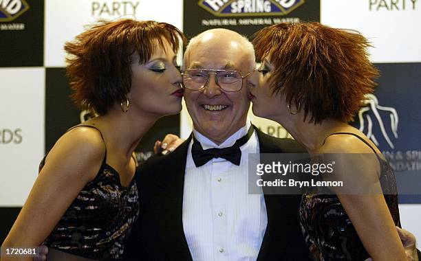Chart-toppers "The Cheeky Girls" pose with ex-Grand Prix comentator Murray Walker during the F1 Awards at the 2003 Grand Prix Party at the NEC Arena...